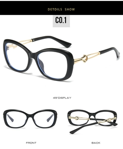 Detail view of large black cat-eye sunglasses with gold interlaced hollow metal temples
