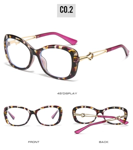 Detail view of cat eye sunglasses with tortoise pattern, gold temples and purple tips