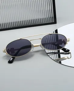 Detail view of oval metal sunglasses featuring a double bridge and H-shaped temple hollow