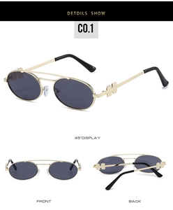 Detail view of oval sunglasses with gold H-shaped metal temple and dark lenses