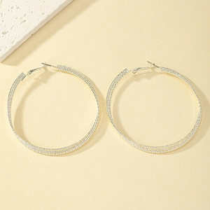 Silver multi-layer twisted hoop earrings with a minimalist triple ring geometric design