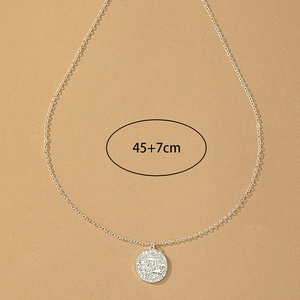Detail view of silver sun coin pendant necklace with 45+7cm adjustable chain link