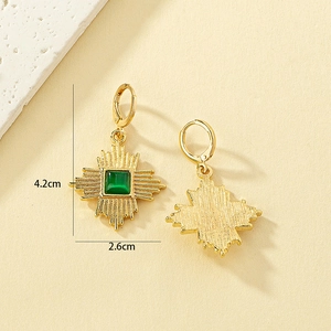 Detailed view of vintage gold sunburst earrings with green cat eye stone and size marking