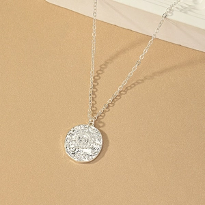 Silver sun coin pendant necklace with embossed medallion and polished cable chain