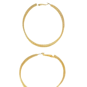 Fashionable oversized gold hoop earrings featuring complex woven mesh texture design