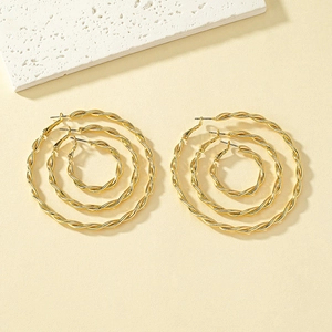 Three pairs of golden twisted hoop earrings in small, medium, and large sizes