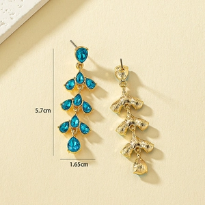 Detailed view of blue teardrop crystal leaf earrings with 5.7cm x 1.65cm dimensions