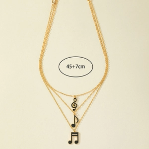 Detail of layered gold music note necklace showing 45+7cm length and enamel pendants