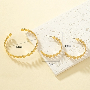 Golden metal leaf texture jewelry set featuring open cuff bracelet and C-shaped earrings