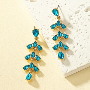 Elegant gold drop earrings with tiered sky blue teardrop crystals on stone decor