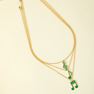 Three-layer gold necklace with green enamel musical note pendants and lobster clasp