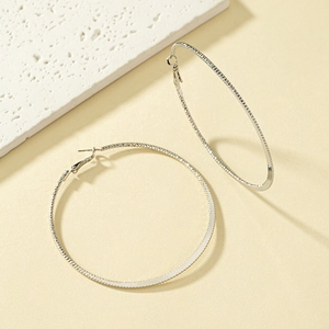 Polished silver textured hoop earrings featuring a woven pattern on a minimalist stone base