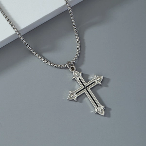 Vintage silver enamel cross pendant necklace with engraved floral edges on grey background