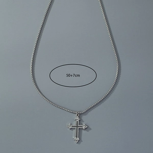 Detail view of gothic cross necklace showing 50+7cm chain length measurement on grey background