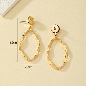 Golden twisted irregular oval hoop earrings with textured finish and 5.2cm height