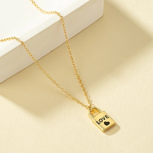 Golden heart lock pendant necklace with LOVE engraving for couples in minimalist style