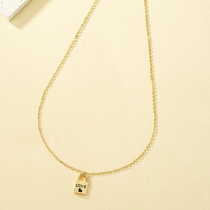 Detailed view of golden heart-shaped lock pendant featuring engraved LOVE lettering