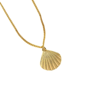 Minimalist shell pendant necklace in gold finish with textured fan shape on white background