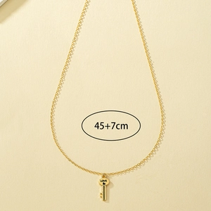 Close-up of golden key pendant with LOVE engraving on a 45+7cm fine link chain