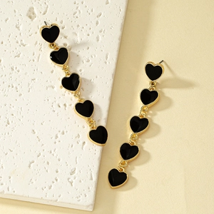 Minimalist gold heart drop earrings featuring five black enamel charms in vertical link