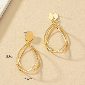 Detailed view of layered gold teardrop earrings with dimensions of 5.7cm by 2.2cm