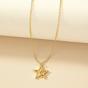 Minimalist gold star pendant necklace with layered double-star design on thin chain