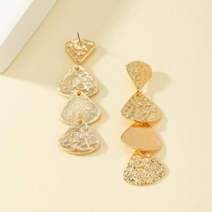 Detail of gold layered tassel earrings with textured fan-shaped geometric alloy metal