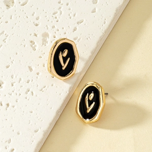 Enamel tulip earrings in irregular gold frames on a natural stone display