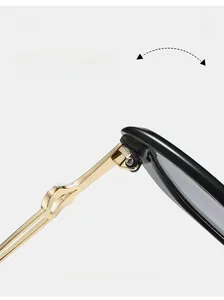 Detail of durable gold metal hinge and twisted temple design on black sunglasses