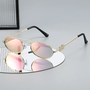 Retro oval sunglasses with gold metal frame and pink gradient lenses for trendy look