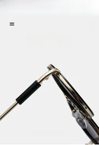 Detailed close-up of premium gold metal hinge and durable black aviator frame