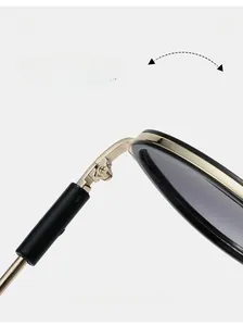 Detailed close-up of a durable golden metal hinge on these oversized pilot sunglasses