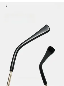 Detail of ergonomic curved mirror legs with gold metal hinge and black comfort ear hooks
