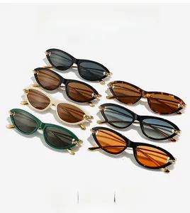 Flat lay display of cat-eye sunglasses featuring golden chain metal temple details