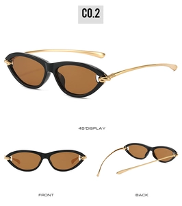 Cat eye sunglasses detail with black frame, brown lenses and gold knotted metal temples