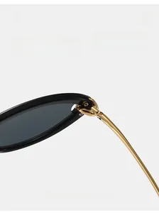Detail of durable gold metal hinge on black cat eye sunglasses with reinforced screws