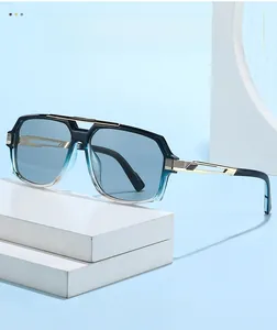 Close-up of stylish blue gradient sunglasses with intricate gold metal hollowed temple detail
