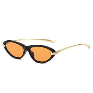 Chic cat eye sunglasses with black frame, orange lenses and gold metal temples