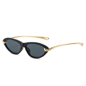 Chic cat eye sunglasses with gold knot detail and dark lenses on white background