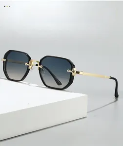Close-up of octagonal frame sunglasses with gold-textured metal temples and gradient lenses