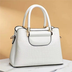 Elegant white stone-textured tote bag with gold hardware and structured silhouette