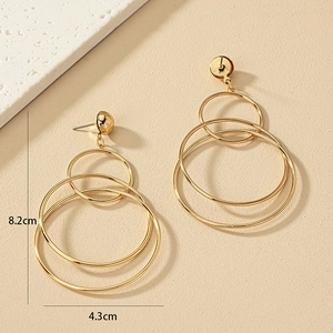 Large golden multi-layer geometric hoop earrings with triple interlocking rings design