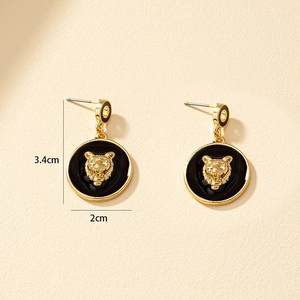 Vintage gold lion head drop earrings with black enamel circle and 3.4cm total length