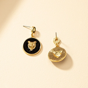 Golden lion head stud earrings with black enamel circles in a high-quality pair set