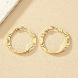 Elegant gold layered triple hoop earrings featuring a stylish twisted metal design for women