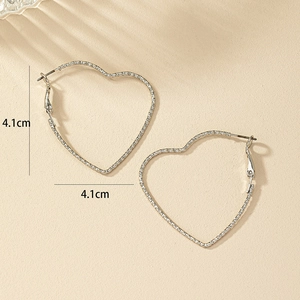 Detail view of 4.1cm silver heart hoop earrings with textured metal finish and size markers