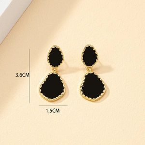 Minimalist black enamel teardrop earrings in gold metal frame measuring 3.6cm by 1.5cm