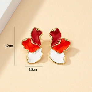 Abstract asymmetric enamel flower earrings in red and orange colors with gold metal trim