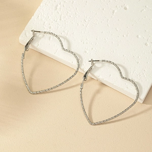 Large silver heart-shaped hoop earrings with textured metal finish for women