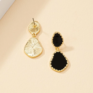 Elegant gold drop earrings with black enamel featuring irregular geometric wave design